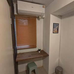 a room with a window with a wooden bench and a fan at Zanit Hostel in Don Muang Airport +41 photos