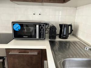 a microwave sitting on top of a kitchen counter at Apartment Malpensa in Somma Lombardo