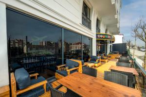 a row of tables and chairs on a patio at Hilltown Airport Hotel & Restaurant in Taşoluk