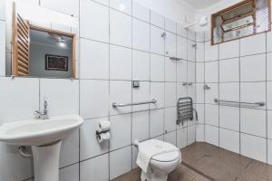 a white bathroom with a sink and a toilet at Hotel Portela II - Av Principal e a 500m do Thermas dos Laranjais in Olímpia +36 photos