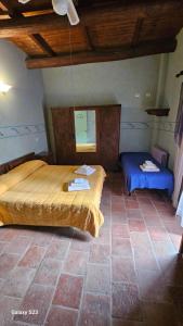 a bedroom with two beds and a mirror in it at Agriturismo La.Ti.Mi.Da. in Cassine