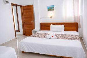 a bedroom with a bed with two towels on it at Coastal lodge in Port Mathurin +5 photos