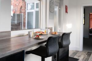 a kitchen with two plates of food on a counter at Spacious and Comfortable - 5 Bedroom Home in Kettering