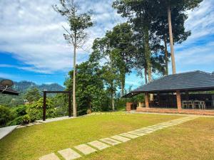 a house with a pavilion in a grassy yard at Jebat D'Manggis Janda Baik - Mountain View in Bentong