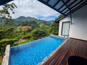 a swimming pool on the deck of a house at Jebat D'Manggis Janda Baik - Mountain View in Bentong