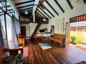 a living room with a couch and a staircase at Jebat D'Manggis Janda Baik - Mountain View in Bentong