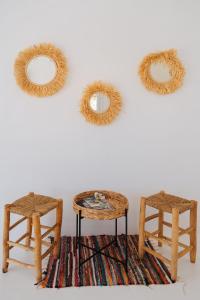 three wicker chairs and a stool and two mirrors at Nissos Suites in Apollonia +48 photos