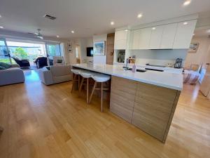 a kitchen with a counter and a living room at Rose Villa - Port Willunga in Port Willunga