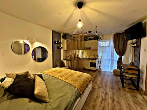 a bedroom with a bed and a living room at VerdeViu Apartments 2 Prima Green Residence in Oradea