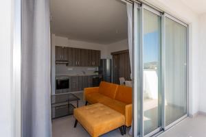 a living room with a couch and a table at BlueBell Limassol Suites in Limassol
