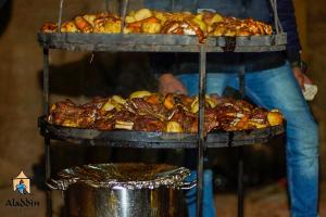 a tray of food on a stand with bread and pastries at Aladdin Camp in Disah