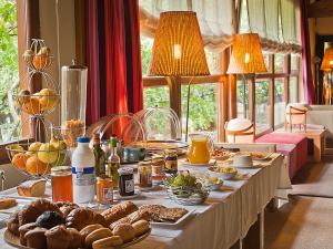 a long table with food and bread on it at Hostal Casa Masip in Ezcaray