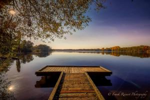 a dock on a lake in the middle of the water at Wellings Romantik Hotel zur Linde in Moers +85 photos