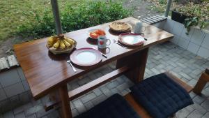a wooden table with plates of food on it at Arche Noah in Kalabahi