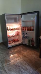 a refrigerator with its door open in a kitchen at Arche Noah in Kalabahi