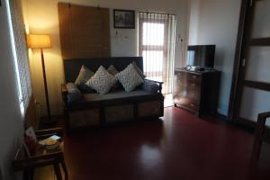 a living room with a couch and a television at The Turquoise Letterbox - Twin at Central in Kolkata