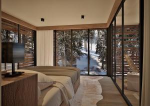 a bedroom with a bed and a large glass window at Mountain Retreat by Dukley in Kolašin