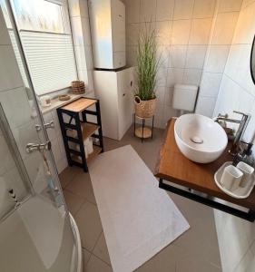 a bathroom with a sink and a toilet and a shower at ZweiundMeer Bungalow 1 in Wiek auf Rügen