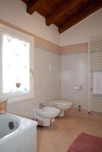 a bathroom with a sink and a toilet and a window at A casa di Giò in Vittorio Veneto