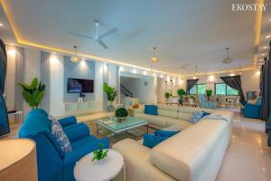 a living room with blue and white furniture at Ekostay Luxe - CASA SIA - Ideal for Big Groups- Poker Table in Lonavala +33 photos
