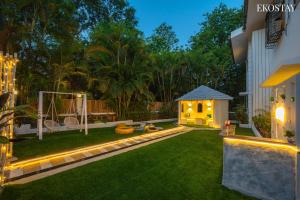 a backyard with a gazebo in the yard at night at Ekostay Luxe - CASA SIA - Ideal for Big Groups- Poker Table in Lonavala