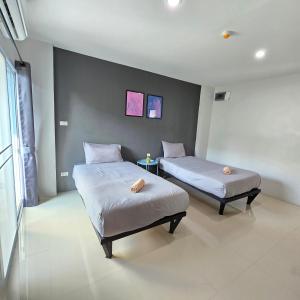 two beds in a room with two beds sidx sidx sidx sidx at Around Loei in Loei