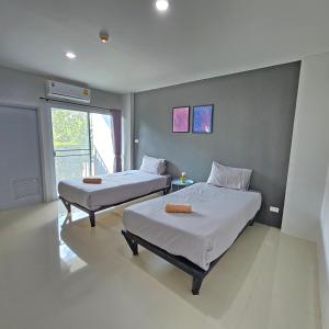 a room with two beds and a window at Around Loei in Loei