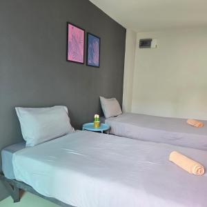 two beds sitting next to each other in a room at Around Loei in Loei
