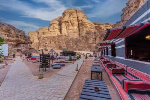 a group of benches in front of a mountain at Aladdin Camp in Disah