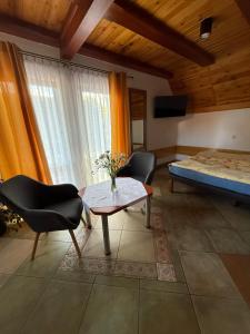 a living room with a table and chairs and a bed at Kama Pobierowo in Pobierowo