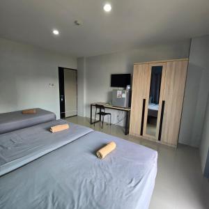 a bedroom with two beds and a desk in it at Around Loei in Loei +42 photos
