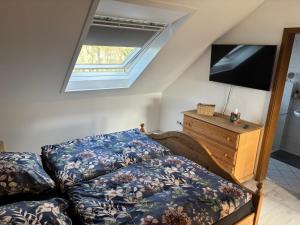 a bedroom with a bed and a flat screen tv at Schöne Maisonette-Wohnung in ruhiger Lage in Oer-Erkenschwick
