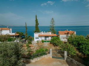 a house on a hill with the ocean in the background at Xiro Retreat in Xiropigado