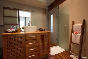 a bathroom with a sink and a glass shower at Luxury Sakina Villa - Beachfront in Dzamandzar