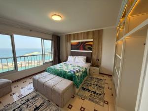 a bedroom with a bed with a view of the ocean at Gleem Sea View 8 in Alexandria