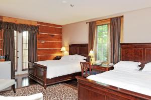a hotel room with two beds and a window at Eganridge Resort, Golf Club & Spa in Bobcaygeon +46 photos