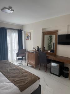 a hotel room with a bed and a desk at La Vista in Gaziemir