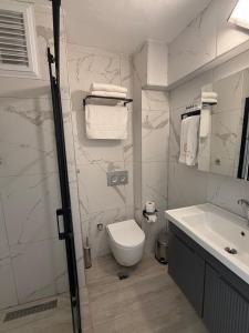 a bathroom with a toilet and a sink at La Vista in Gaziemir +28 photos