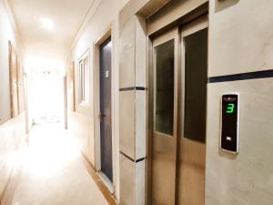 a hallway with a door with the number on it at TIP TOP PG - Paying Guest in Phagwāra