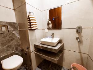 a bathroom with a sink and a toilet at TIP TOP PG - Paying Guest in Phagwāra