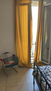 a bedroom with a bed and a chair and a window at Governo Provvisorio House in Milan