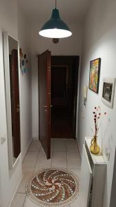 a hallway with a door and a rug on the floor at Governo Provvisorio House in Milan