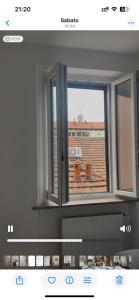 a window with a view of a building at Governo Provvisorio House in Milan