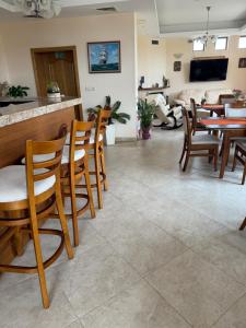 a living room with wooden chairs and a table at Златна люспа in Bŭlgarevo