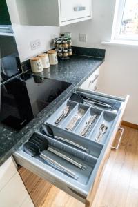 an open kitchen drawer with utensils in it at Vyn's Holiday home - Sleeps 6 in Cardiff