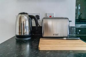 a toaster sitting on top of a kitchen counter at Vyn's Holiday home - Sleeps 6 in Cardiff