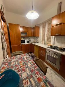 a kitchen with a table with a blanket on it at La Vanitas in Cremona
