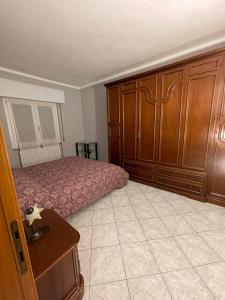 a bedroom with a bed and wooden cabinets at La Vanitas in Cremona