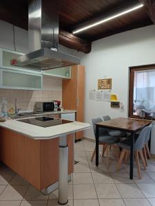 a kitchen with a sink and a table with chairs at La casetta di nonna Sesa in Viterbo