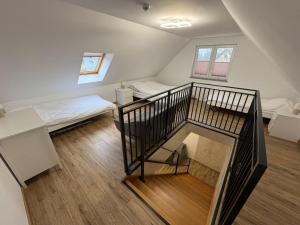 a room with a staircase and a room with a bed at Apartamenty w Kotlinie in Lądek-Zdrój